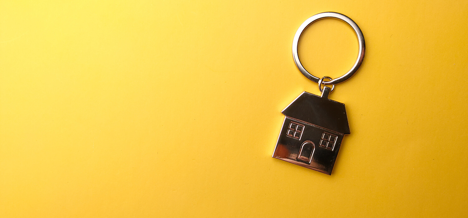 House Keychain on a Yellow Background