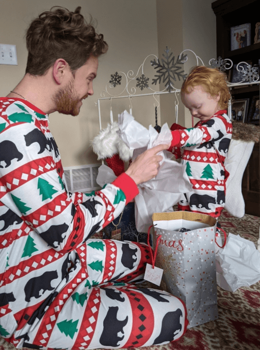 A photo of a Sunrise employee in Christmas pajamas with a child in matching pajamas