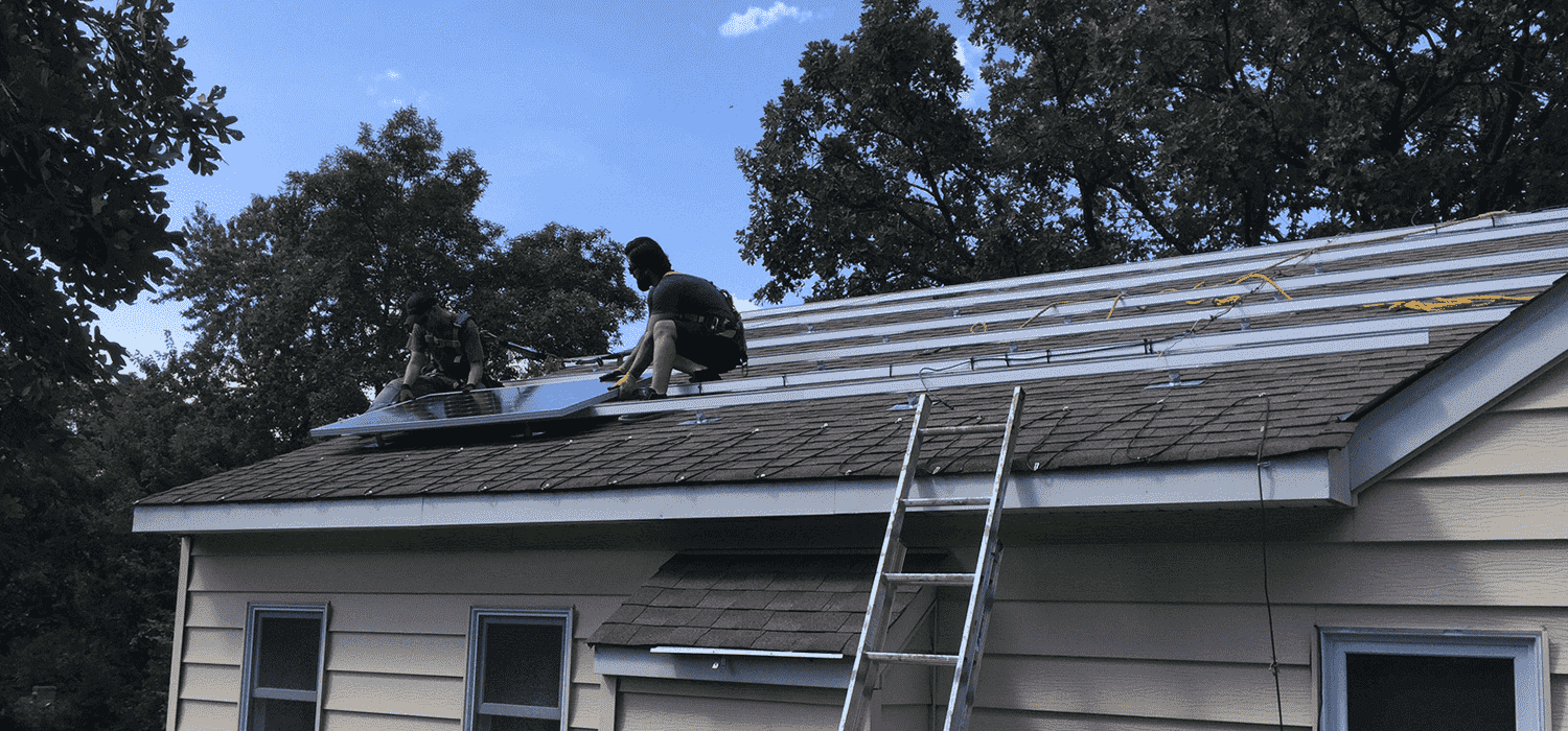 People on roof installing solar panels