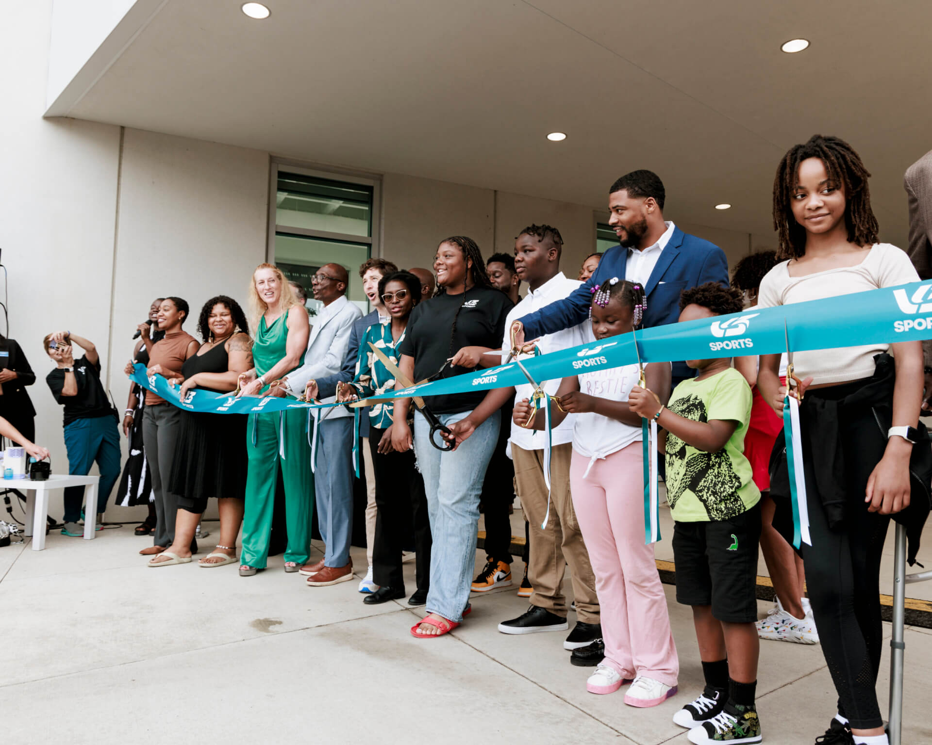 Grand opening with people cutting the ribbon at V3 Sports Center