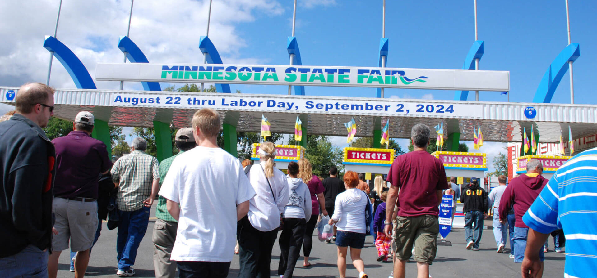 People walking through the front gates of the Minnesota State Fair.