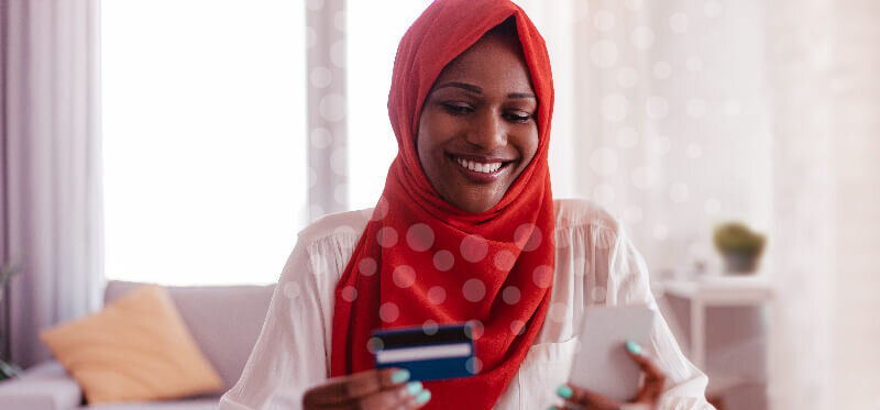 A young woman views her increased credit score on her cell phone