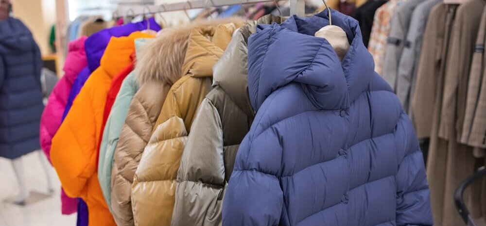 A rack of adult-sized winter coats in multiple colors.