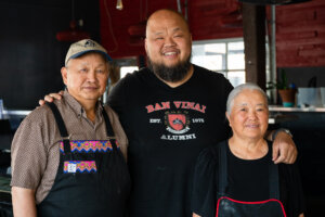 Three people standing together. 