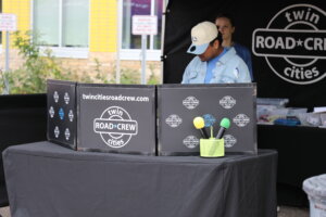 A person standing behind a DJ booth.