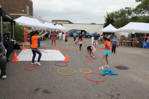 A group of kids playing with hula hoops.