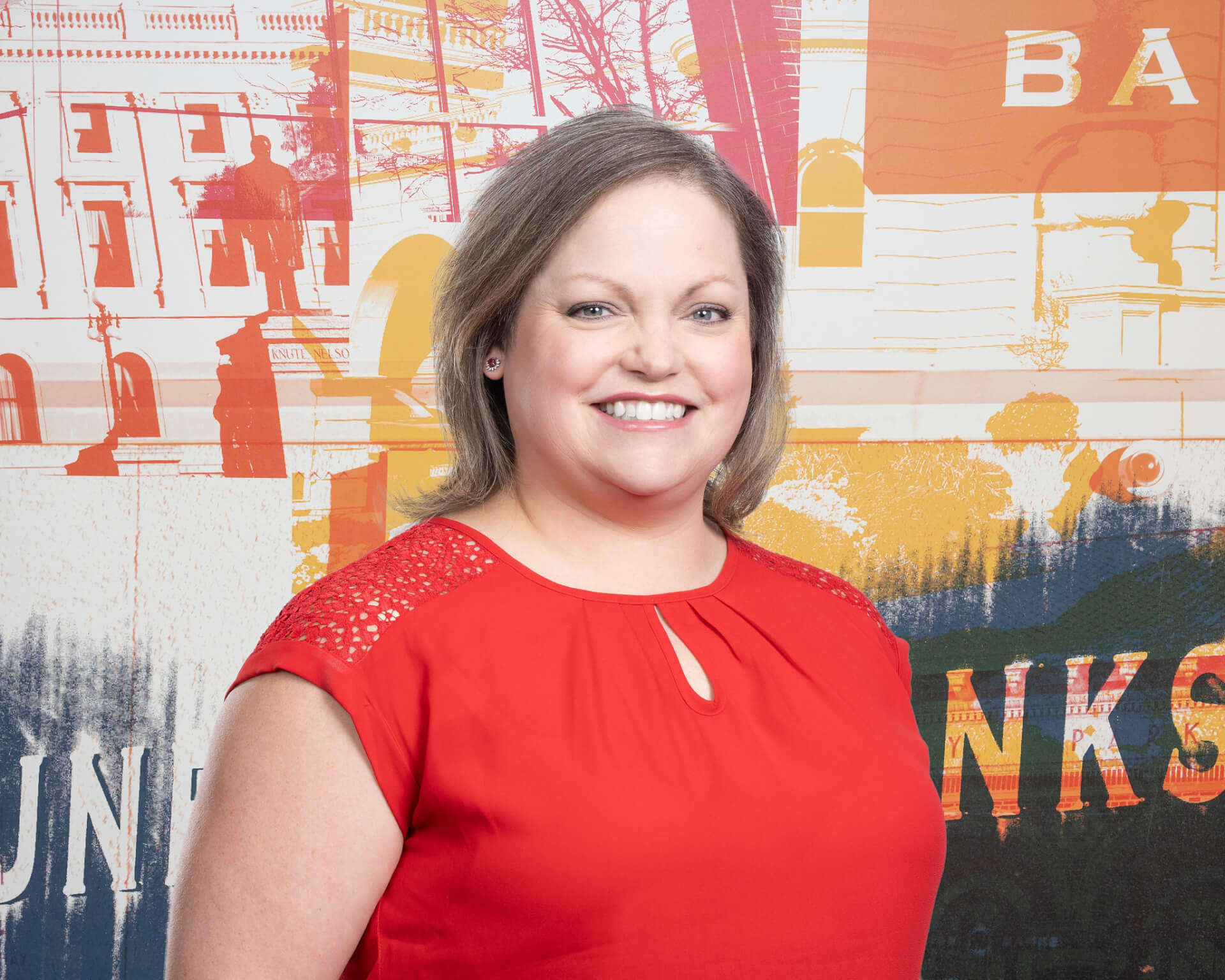 Headshot of Amanda Theisen against a mural background.