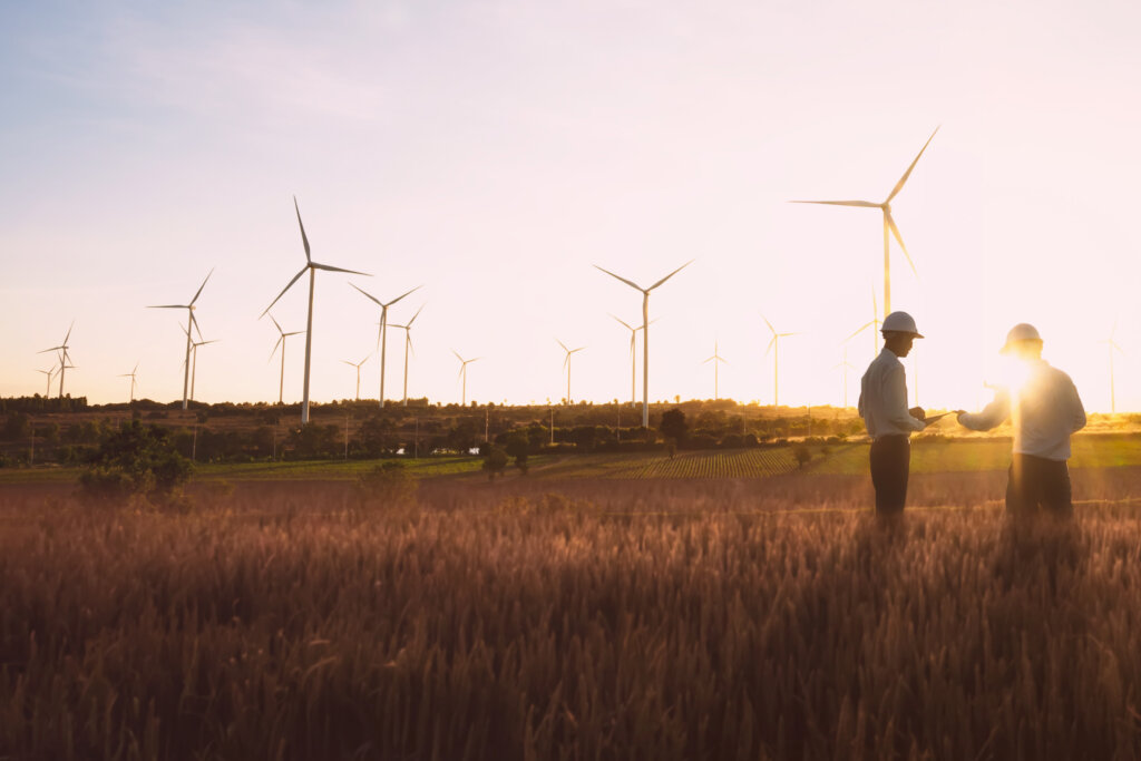 Two men discussing in wind field