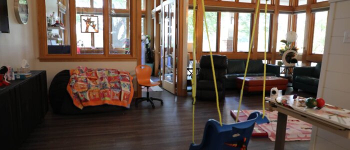 A therapy swing in a living room at Crescent Cove.