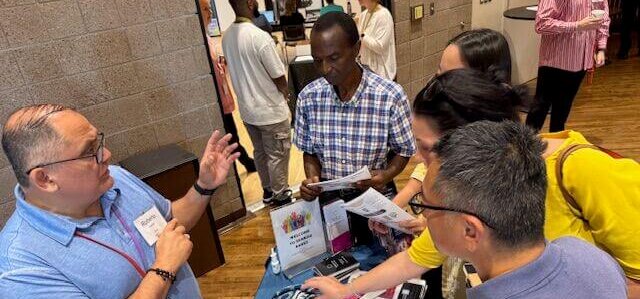 Roberto Valdizan talking to immigrant business owners