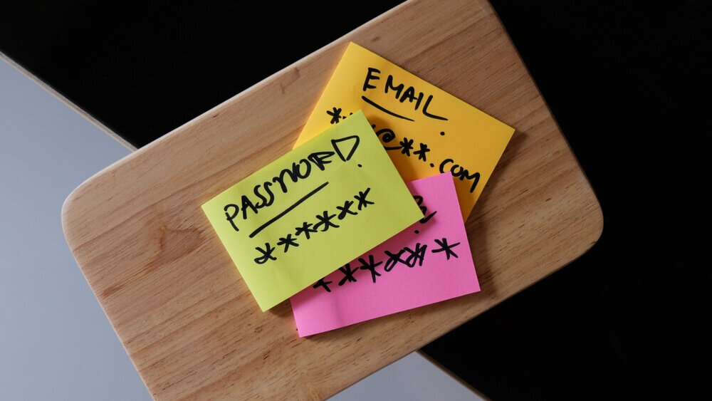 sticky notes with hidden email and password written on them