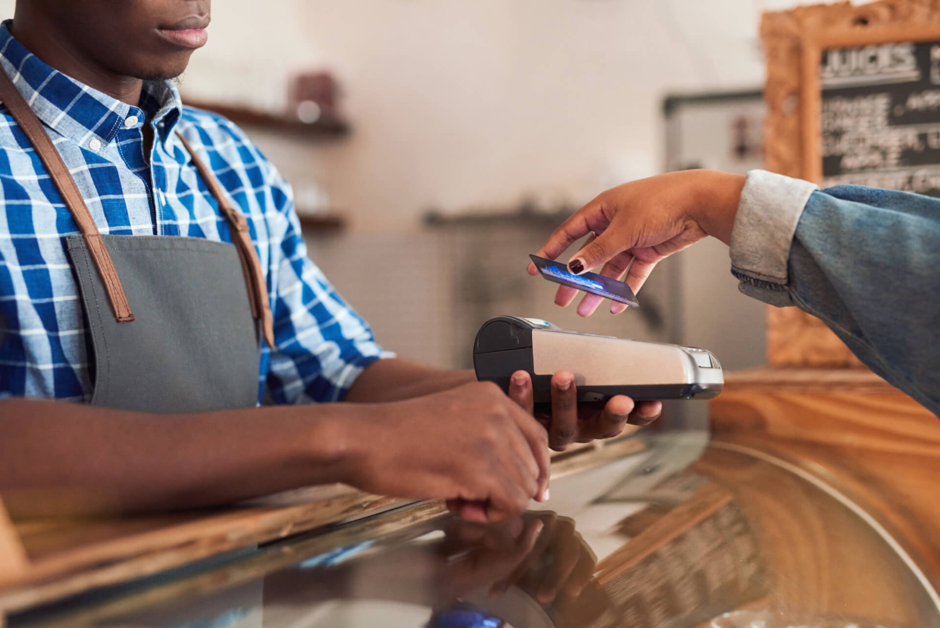 A shop owner accepts a card payment