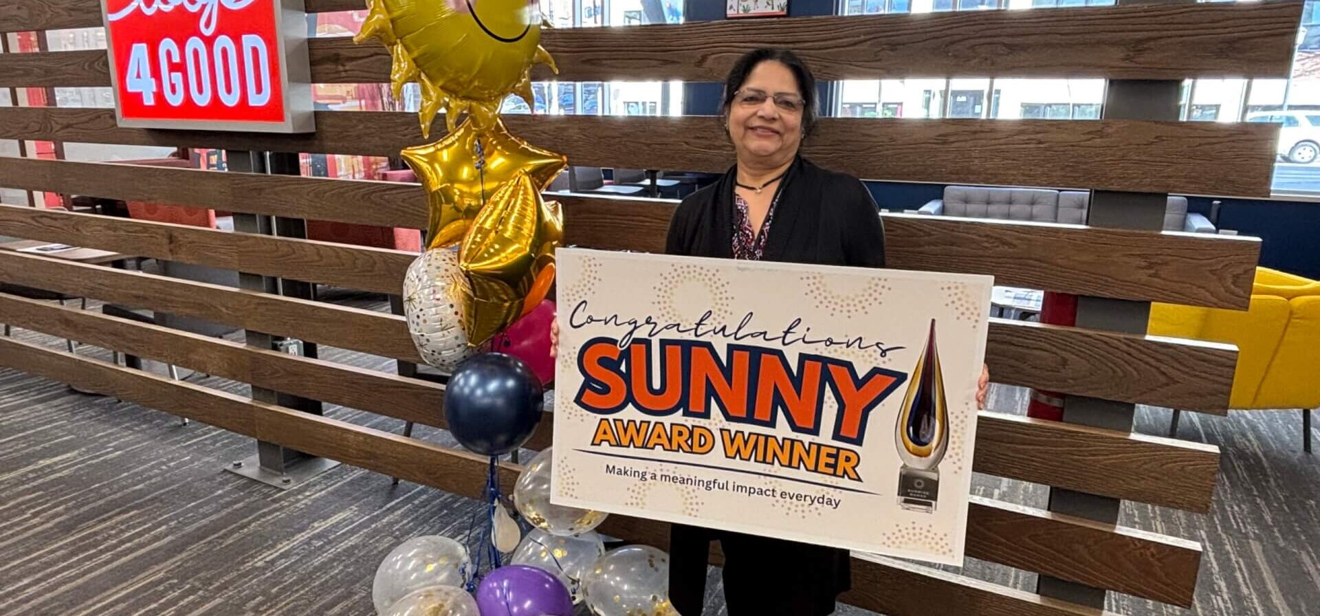 Anjali Sharma holding her Sunny Award Winner sign.