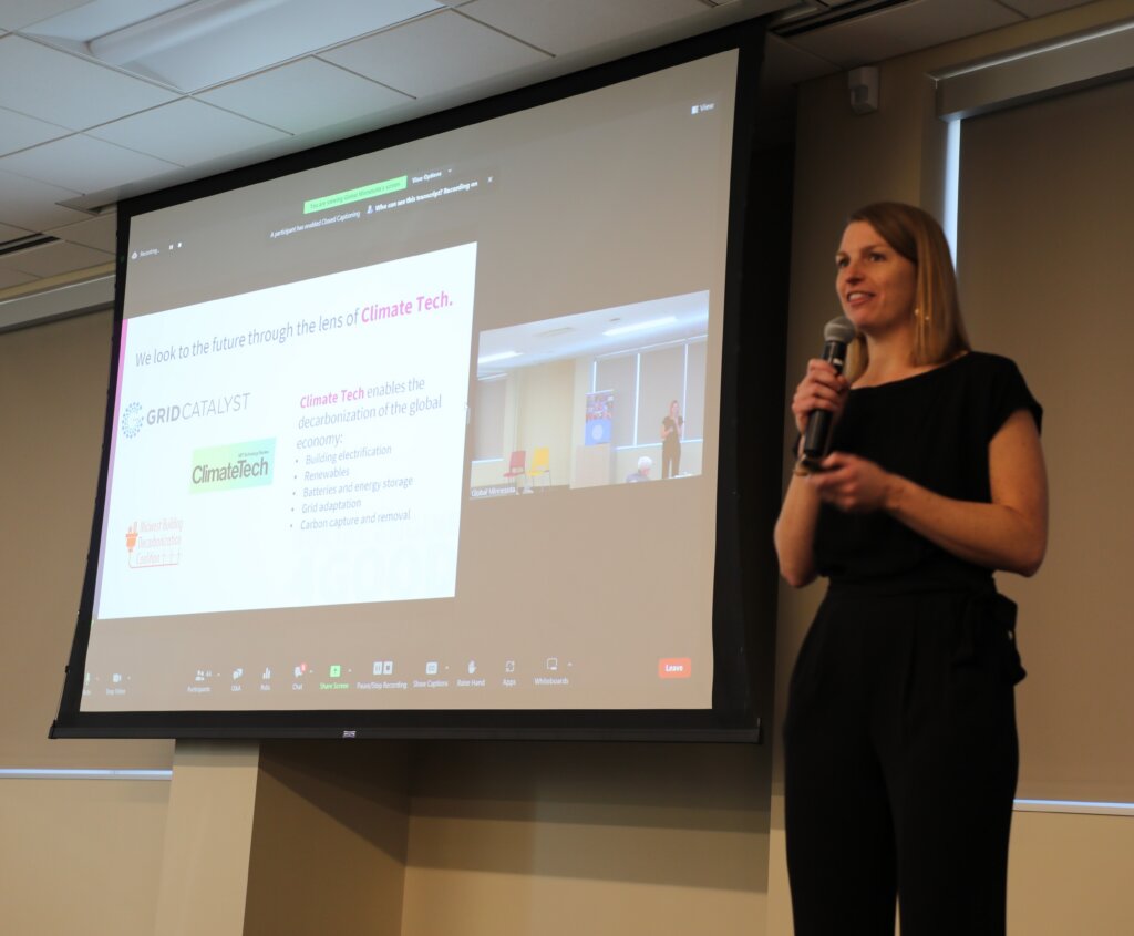 Laura Wildenborg giving a presentation with a screen in the background.