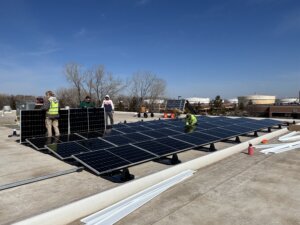 Workers installing rooftop solar panels