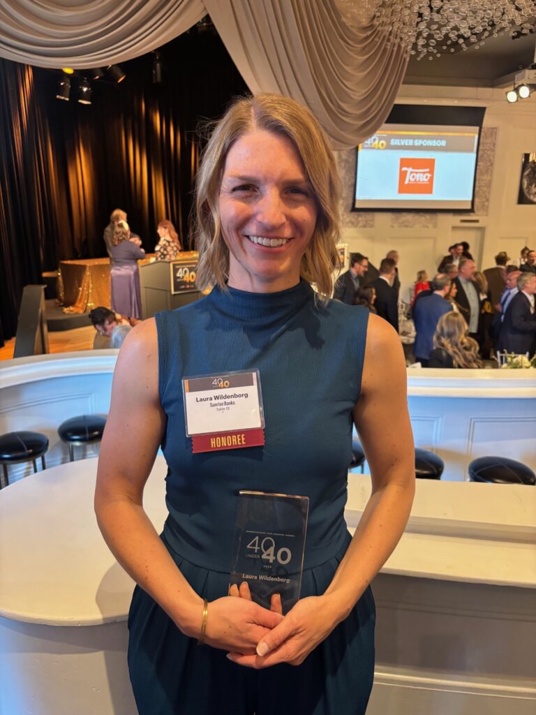Laura Wildenborg holding her "40 Under 40" award.