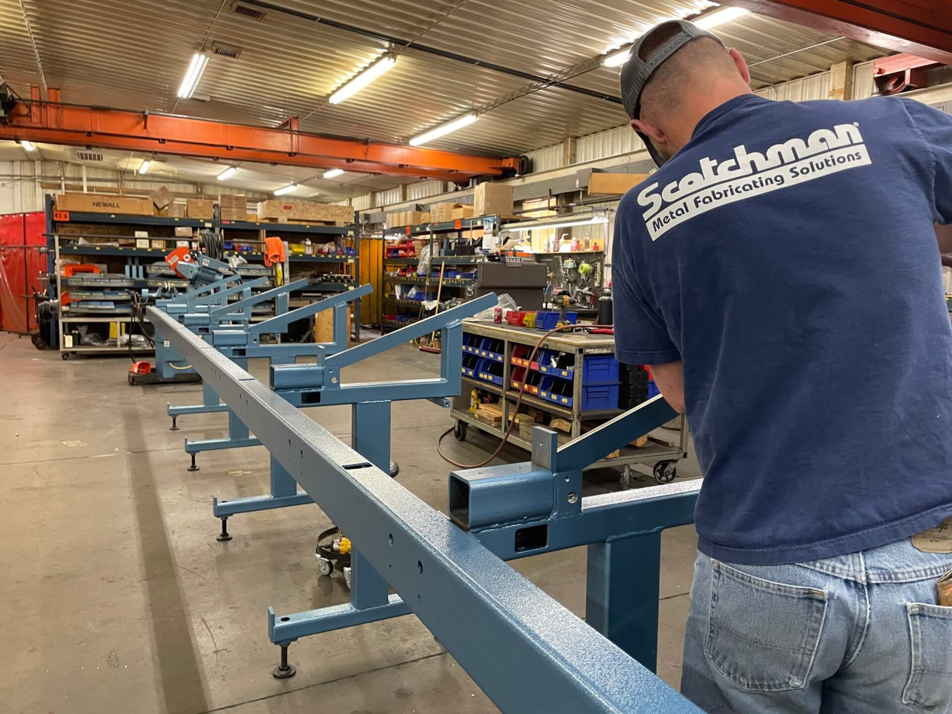 An employee at Scotchman Industries works on a piece of equipment.