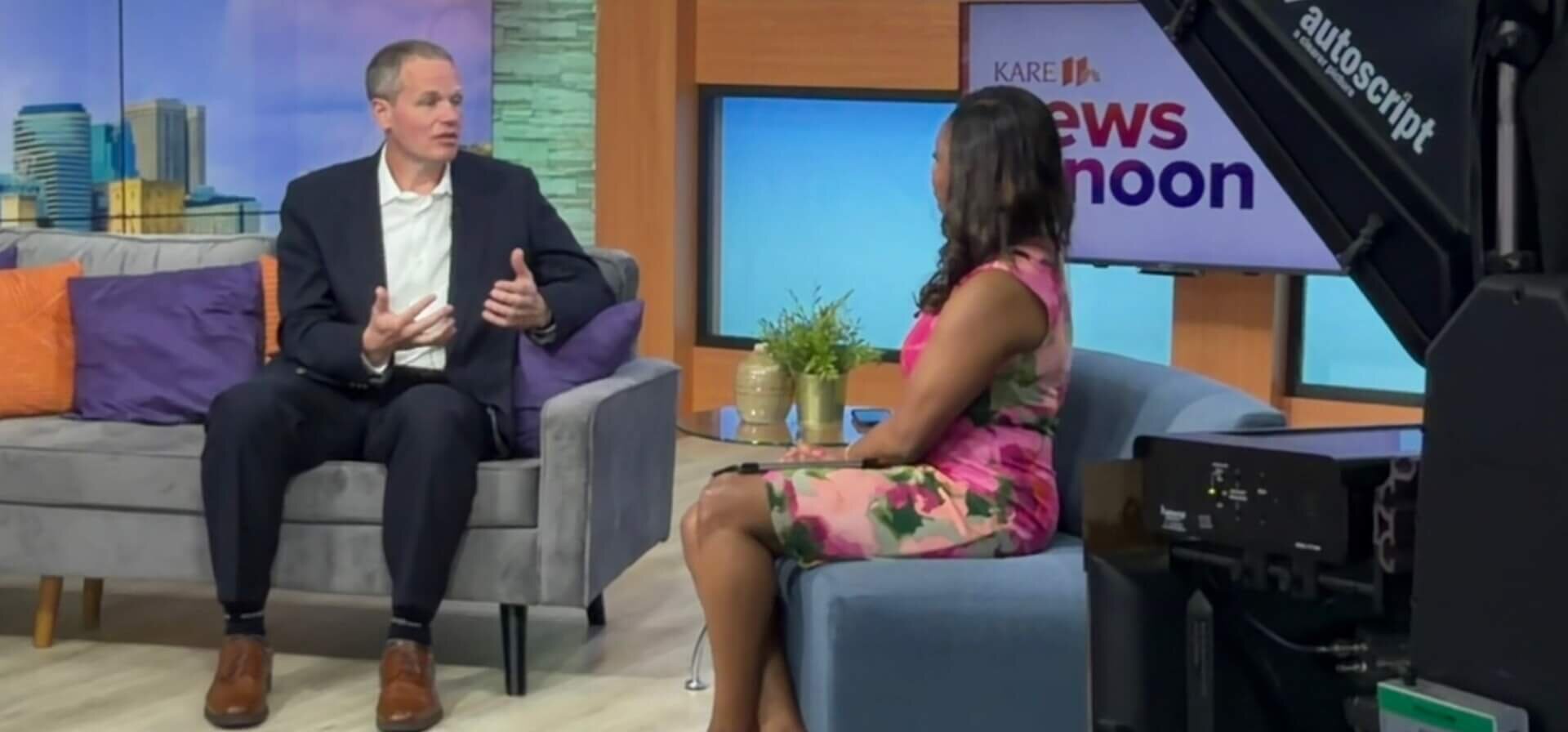 Todd Sharkey on the interview set at KARE 11 News speaking with anchor CeCe Gaines.