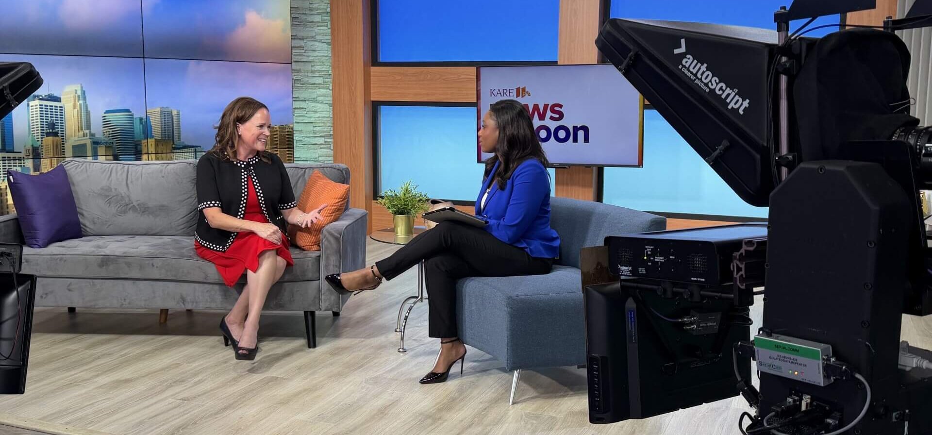Two women sitting on a television news set.