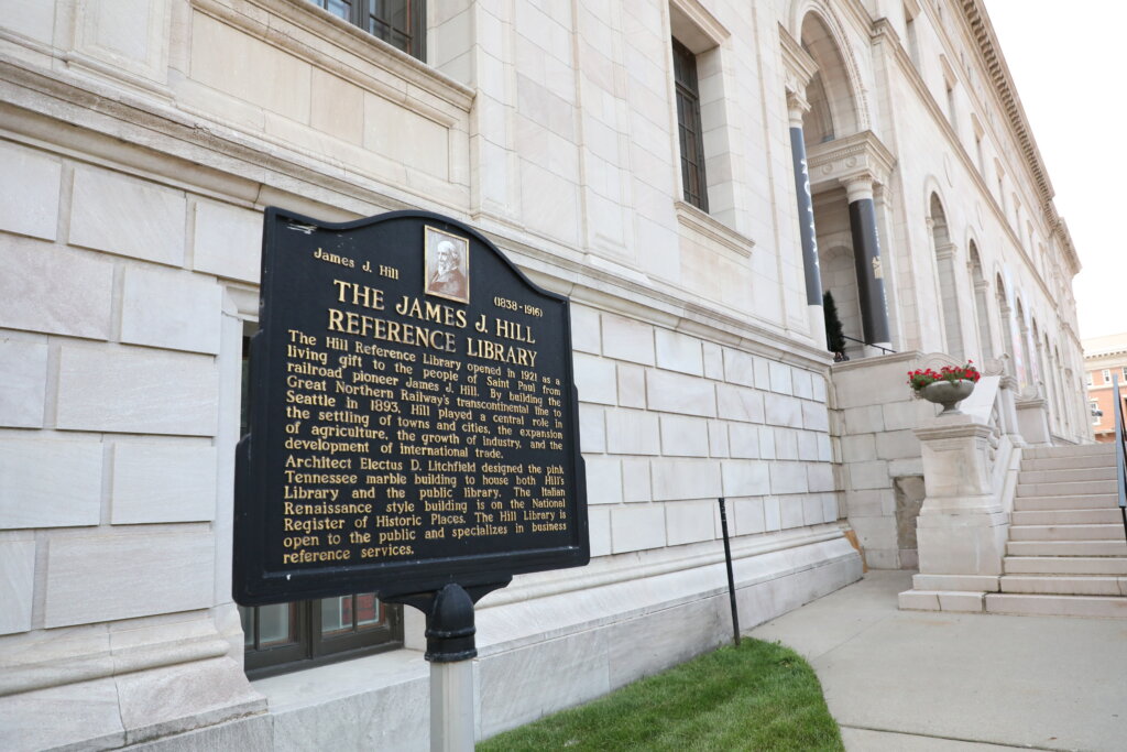 A sign outisde the James J. Hill Reference Library about its spot on the National Register of Historic Places.